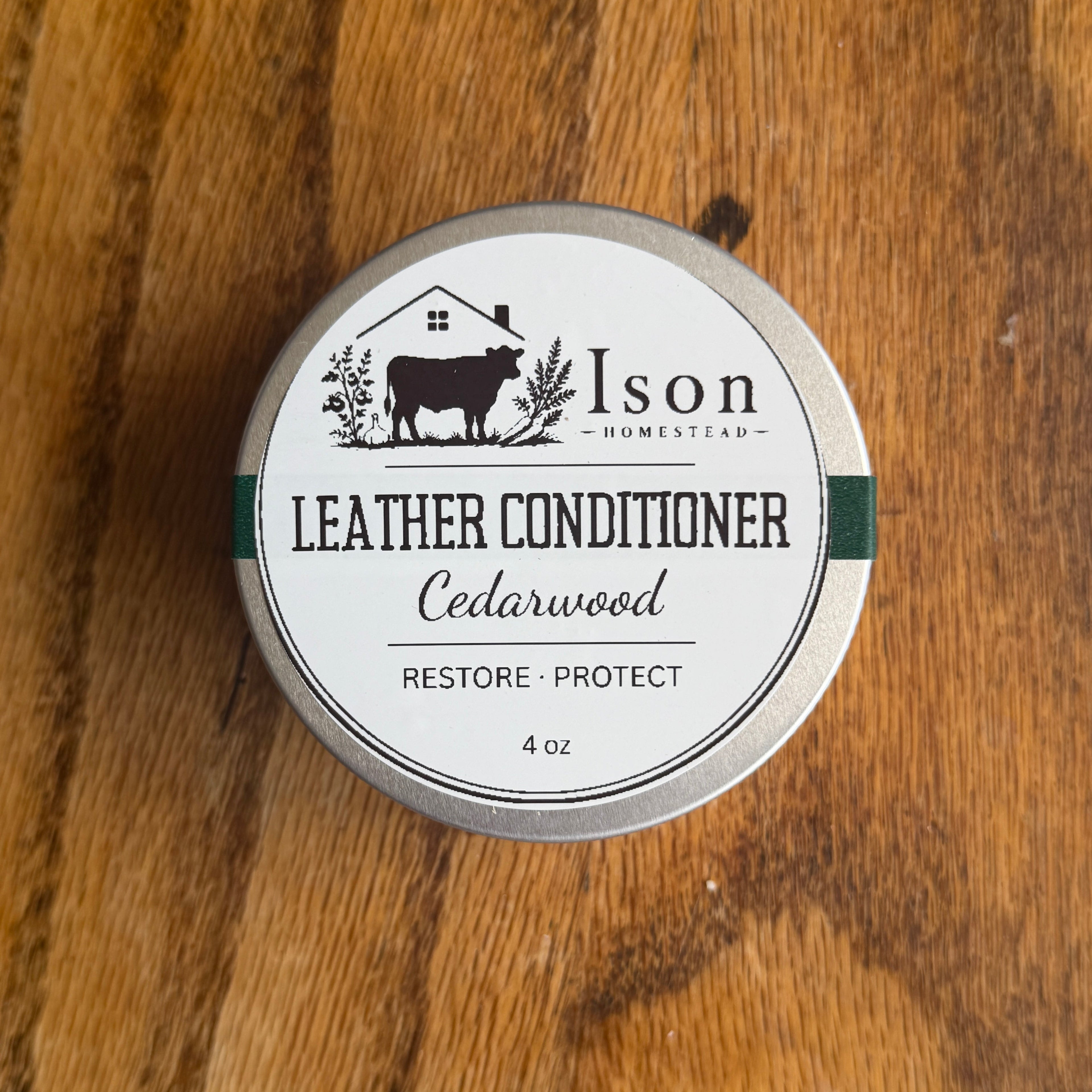 Ison Homestead leather conditioner tin on a wooden surface