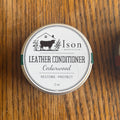 Ison Leather Conditioner container on a wooden surface