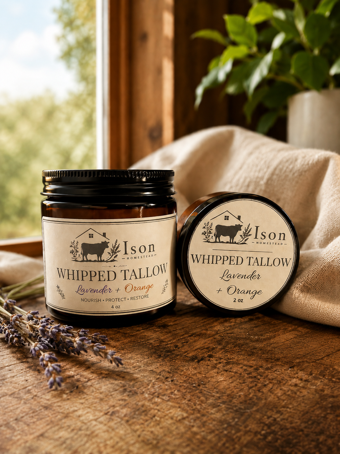 Two jars of Ison Whipped Tallow on a wooden surface with a blurred natural background