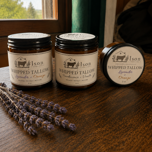 Three jars of Ison Whipped Tallow on a wooden surface with lavender.